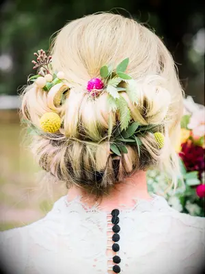 wedding hair flowers wildflowers in low bun