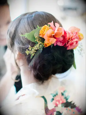 wedding hair flowers colorful floral barrette above low bun