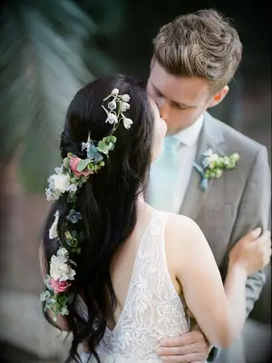 wedding hair flowers braided half up with greenery woven in