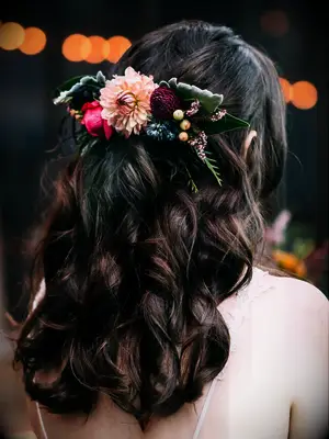 wedding hair flowers half up with dark moody florals