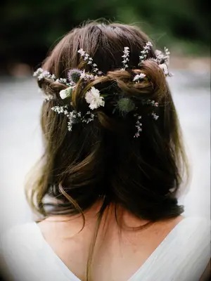 wedding hair flowers half up with white flowers woven in