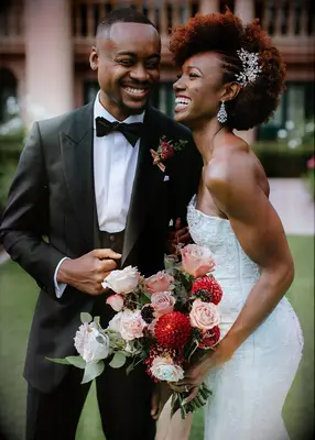 Afro with braided side part and jumbo barrette Black wedding hairstyle