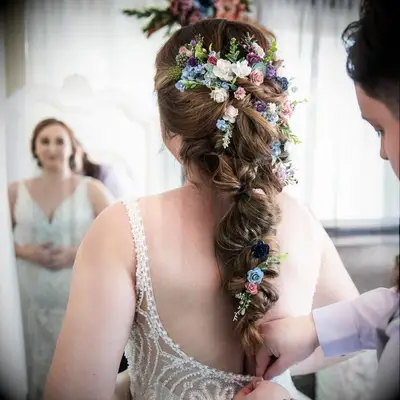 Wildflower-embellished braid wedding hairstyle