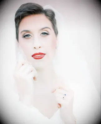 Short pixie cut wedding hairstyle with red lip and veil
