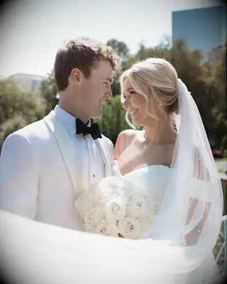 Wedding updo for short hair with pearl-adorned veil