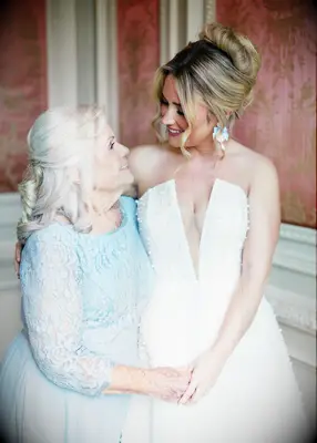 Half up loose curl medium length mother of the bride hairstyle