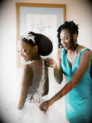 Curly mother of the bride hairstyle with loose tendrils 