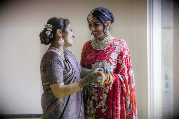 Low bun with flowers elegant mother of the bride hairstyle