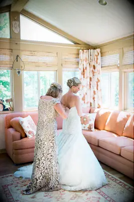 Half up medium length mother of the bride hairstyle with hair accessory