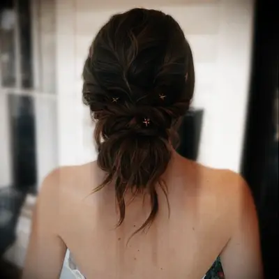 Tousled updo with star ornaments medium length wedding hairstyle