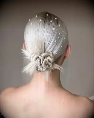 Pearl-adorned bridal updo for medium length hair