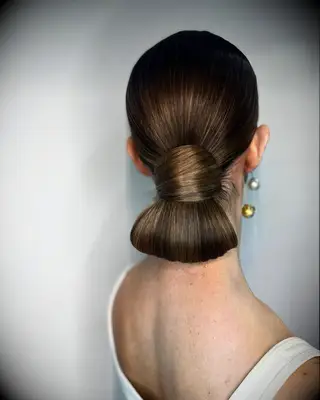 Sleek bun medium-length wedding hairstyle