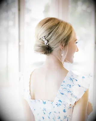 Wedding day updo with pearl hairpiece for medium length hair