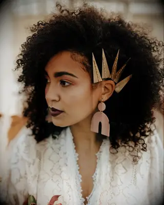 Natural curls with gold hair accessories wedding hairstyle for medium length hair