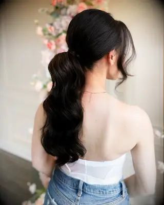 Low ponytail with bump and bangs wedding hairstyle