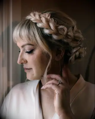 Milkmaid braid bun with bangs bridal hairstyle