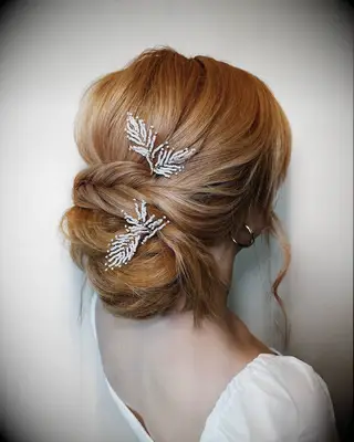 Low messy bun with bangs wedding hairstyle
