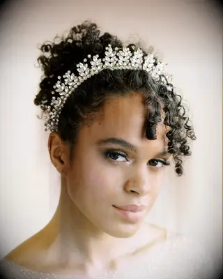 Curly thin wedding with crown hairstyle 