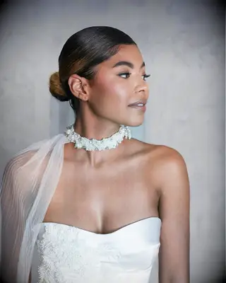 Slicked back bun thin wedding hairstyle