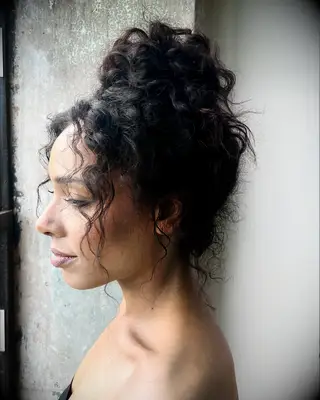 Curly top knot thin wedding hairstyle
