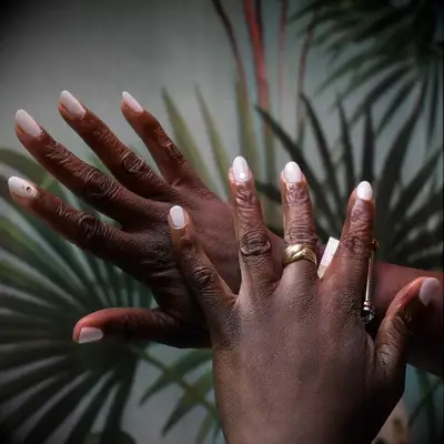 Milky white wedding nails with jewel accents