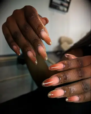 Burnt orange ombre bridesmaid nails with gold glitter tips