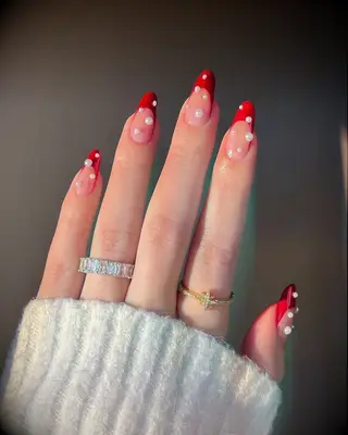 Red tip bachelorette nails with pearls