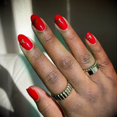 Red wedding nails with gold bow details