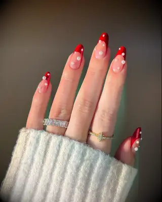 Red French tip wedding nails with pearl embellishments