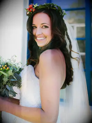 Long, loose curls with a wildflower wedding crown and veil