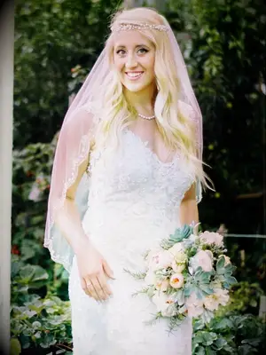 Gold halo crown with embellished flowers and an elbow-length veil