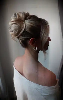 Curly updo with face-framing strands bridesmaid hairstyle