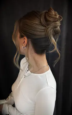 Loose updo with face-framing waves bridesmaid hairstyle