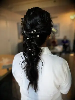 Wavy fishtail braid with pearl embellishments bridesmaid hairstyle