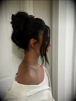 Messy topknot with curls bridesmaid hairstyle