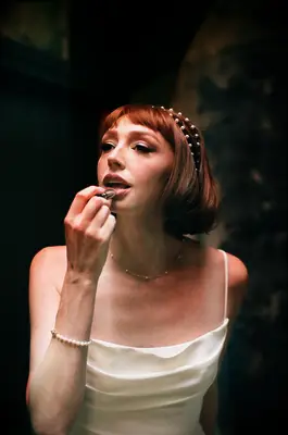 Short bridesmaid hairstyle idea with bangs and headband