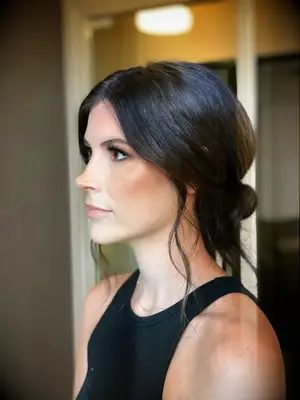 Loose low bun with face-framing strands bridesmaid hairstyle