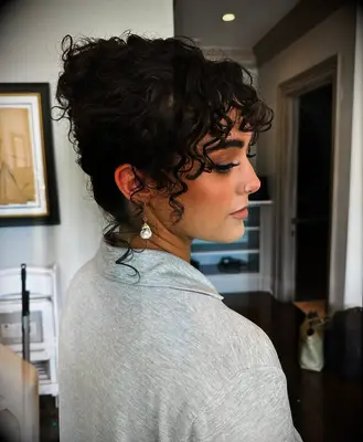 Coily updo with bangs bridesmaid hairstyle