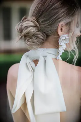 Messy low bun with face-framing strands bridesmaid hairstyle