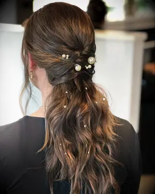 Low ponytail with pearl pins wedding hairstyle