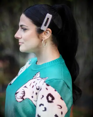 Curled ponytail with pearl barette wedding hairstyle