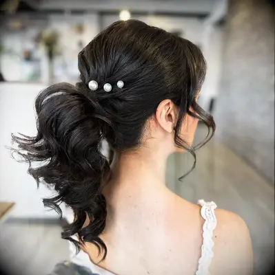 Wedding ponytail hairstyle with pearl accessories