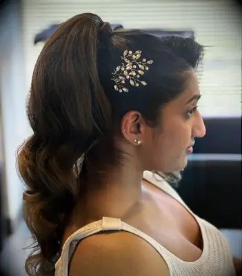 Glam ponytail with floral comb wedding hairstyle