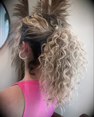 Naturally curly ponytail wedding hairstyle