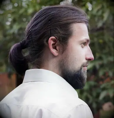 Short ponytail with bobby-pinned bangs wedding hairstyle