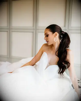 Sleek ponytail with glam curls wedding hairstyle