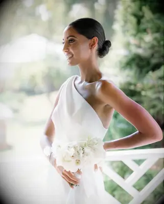 Sleek bun one shoulder gown bridal hairstyle