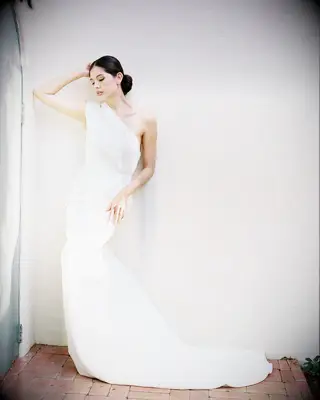 Center-Parted Bun one shoulder gown bridal hairstyle