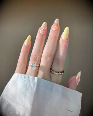 Pastel yellow daisies engagement nail inspiration