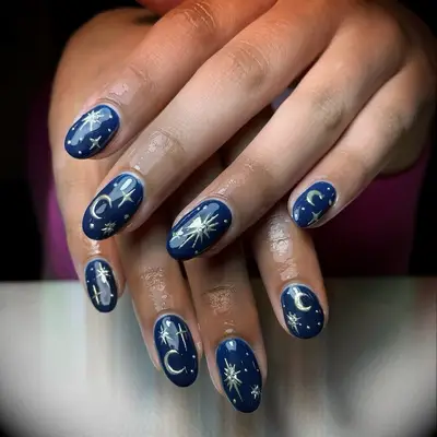 Navy blue and gold celestial engagement nail inspiration